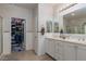 Charming bathroom with double sinks, crystal light fixtures, and access to a well-organized closet at , North Las Vegas, NV 89031