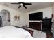 Bright bedroom with a large screen TV, wood floors, and a view into the ensuite bathroom at , North Las Vegas, NV 89031