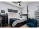 Cozy bedroom with dark wood floors, modern ceiling fan, and a storage unit with clear bins at , North Las Vegas, NV 89031