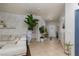 Bright hallway showcasing a decorative table and a large plant, with neutral tile flooring at , North Las Vegas, NV 89031