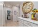 Hallway featuring a decorative clock, flowers, and a view into another room at , North Las Vegas, NV 89031