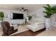 Spacious living room with a plush white sectional sofa, ceiling fan, and a large flatscreen TV at , North Las Vegas, NV 89031