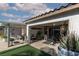 Relaxing covered patio space with seating area and artificial grass, perfect for outdoor living and entertaining at , North Las Vegas, NV 89031