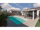 Sparkling pool with a pergola and seating area, surrounded by lush greenery and a clear blue sky at , North Las Vegas, NV 89031