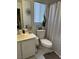 Bathroom with tub-shower combo, vanity, and toilet at 10265 Moth Orchid Ct, Las Vegas, NV 89183