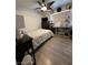 Cozy bedroom with laminate flooring, ceiling fan, and closet space at 10265 Moth Orchid Ct, Las Vegas, NV 89183