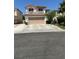 Two-story home with a two-car garage and tile roof at 10265 Moth Orchid Ct, Las Vegas, NV 89183