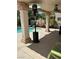 Covered patio area with ceiling fan, providing a comfortable outdoor space overlooking the pool and backyard at 10265 Moth Orchid Ct, Las Vegas, NV 89183