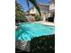 Backyard pool with lounge chairs and mature landscaping; perfect for outdoor entertaining and relaxation at 10265 Moth Orchid Ct, Las Vegas, NV 89183