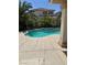 Beautiful backyard pool with a custom design and inviting ambiance, surrounded by lush tropical landscaping at 10265 Moth Orchid Ct, Las Vegas, NV 89183