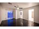 Spacious bedroom offering hardwood floors, closet, and doors to an attached balcony at 10414 Midseason Mist St, Las Vegas, NV 89183