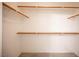 Spacious walk-in closet with wood shelving for ample storage and organization at 10414 Midseason Mist St, Las Vegas, NV 89183
