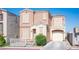 Inviting two-story home with a well-maintained front yard and a charming covered porch entrance at 10414 Midseason Mist St, Las Vegas, NV 89183