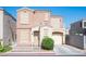 Inviting two-story home with a well-maintained front yard and a charming covered porch entrance at 10414 Midseason Mist St, Las Vegas, NV 89183