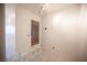 Hallway with glass brick detail leading to a bedroom with hardwood floors and natural light at 10414 Midseason Mist St, Las Vegas, NV 89183