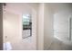 Bright hallway showcasing neutral tile flooring, arched entryway, and clean, white walls at 10414 Midseason Mist St, Las Vegas, NV 89183