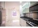 The kitchen includes stainless steel appliances, granite countertops, and an adjacent dining area at 10414 Midseason Mist St, Las Vegas, NV 89183