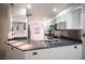 Close-up of modern kitchen with granite countertops, stainless steel appliances and custom pendant lighting at 10414 Midseason Mist St, Las Vegas, NV 89183