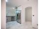 Well-lit kitchen featuring stainless steel appliances, granite counters, and neutral tile flooring at 10414 Midseason Mist St, Las Vegas, NV 89183