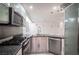 Modern kitchen with stainless steel appliances and granite countertops at 10414 Midseason Mist St, Las Vegas, NV 89183