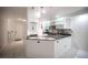 Open concept kitchen featuring granite countertops, stainless steel appliances, and custom pendant lighting at 10414 Midseason Mist St, Las Vegas, NV 89183