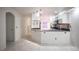 Open concept kitchen with sleek cabinetry, stainless steel appliances, and marble tile flooring at 10414 Midseason Mist St, Las Vegas, NV 89183