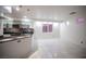 Open concept kitchen with sleek cabinetry, stainless steel appliances, and marble tile flooring at 10414 Midseason Mist St, Las Vegas, NV 89183