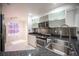 Modern kitchen featuring stainless steel appliances, glass front cabinets and granite countertops at 10414 Midseason Mist St, Las Vegas, NV 89183