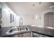 Granite countertops and stainless steel sink in this kitchen area at 10414 Midseason Mist St, Las Vegas, NV 89183