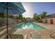 Community pool featuring clear blue water and lounge chairs at 10414 Midseason Mist St, Las Vegas, NV 89183