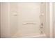 A well-lit, tiled bathtub with built-in shelving and chrome fixtures for a clean appearance at 10414 Midseason Mist St, Las Vegas, NV 89183