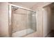 Modern shower featuring tile surround and sliding glass door at 10414 Midseason Mist St, Las Vegas, NV 89183