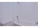 Bathroom featuring a shower and bathtub combo with a white tile surround at 145 Aqua Commons Ln, Henderson, NV 89015