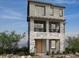 Modern three-story home featuring stone accents, a small balcony, and large windows at 1536 Little Penguin St, Las Vegas, NV 89138