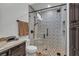 Bathroom featuring a tiled walk-in shower with glass doors and neutral-toned vanity at 1616 Villa Rica Dr, Henderson, NV 89052