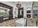 Bright bathroom with a standalone tub, vanity with double sinks, walk-in shower and decorative chandelier at 1616 Villa Rica Dr, Henderson, NV 89052
