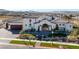 A stucco home featuring a tile roof, arched entry, exterior lanterns, and meticulous landscaping at 1616 Villa Rica Dr, Henderson, NV 89052