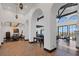 Spacious foyer highlighting tile floors, arched entryways, exposed beam, and an adjacent formal dining room at 1616 Villa Rica Dr, Henderson, NV 89052