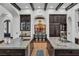 Open kitchen featuring double islands with stone countertops and dark wood cabinetry, flowing into the dining area at 1616 Villa Rica Dr, Henderson, NV 89052