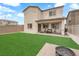 Beautiful backyard features manicured lawn, cozy patio, and a seating area with a fire pit at 1631 Desert Path Ave, North Las Vegas, NV 89032