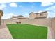 A beautifully landscaped backyard featuring lush grass, a patio, and mature trees at 1631 Desert Path Ave, North Las Vegas, NV 89032