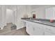 Clean, bright bathroom with modern vanity, gray countertop, and walk-in shower at 1631 Desert Path Ave, North Las Vegas, NV 89032