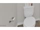 Clean powder room with white toilet and chrome toilet paper holder at 1631 Desert Path Ave, North Las Vegas, NV 89032