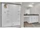 Modern bathroom features glass shower, and spacious vanity with white cabinets at 1631 Desert Path Ave, North Las Vegas, NV 89032