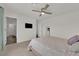 Bright bedroom with a plush bed, television, and mirror at 1631 Desert Path Ave, North Las Vegas, NV 89032