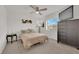 Bedroom featuring carpet, ceiling fan, dark armoire, and large window at 1631 Desert Path Ave, North Las Vegas, NV 89032