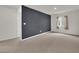Spacious bedroom with a dark accent wall and carpeted floors at 1631 Desert Path Ave, North Las Vegas, NV 89032