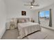 Bright bedroom with a plush bed, side tables, and a view of the neighborhood at 1631 Desert Path Ave, North Las Vegas, NV 89032