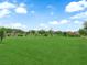 Expansive community park featuring lush green grass, walking trails, and mature trees at 1631 Desert Path Ave, North Las Vegas, NV 89032