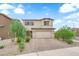 Inviting two-story home with a well-maintained front yard and brick driveway at 1631 Desert Path Ave, North Las Vegas, NV 89032
